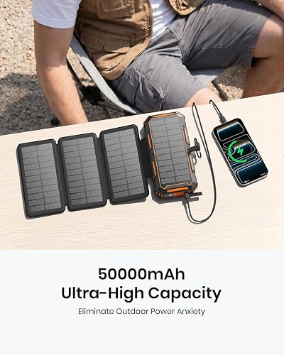 FEELLE Solar Power Bank 50000mAh with its four solar panels fanned out while charging a phone