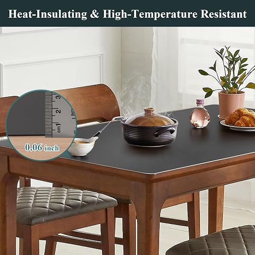 A hot pot resting on the FURKIT PVC table protector over a wood dining table, with a ruler showing its thin profile