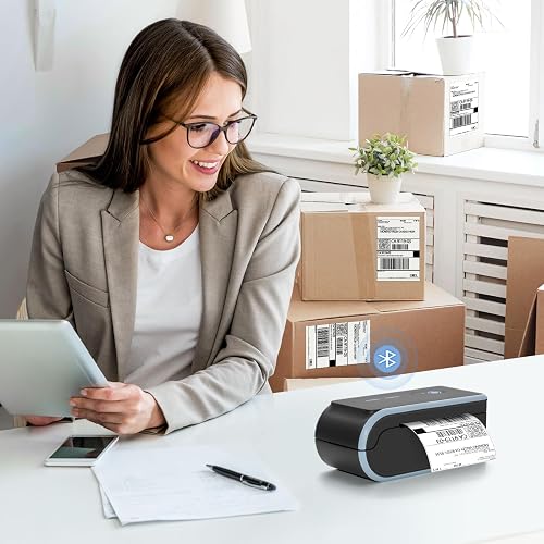 The JADENS Bluetooth label printer printing from a tablet on a home shipping desk